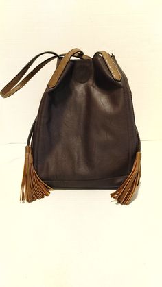 Expandable, lots of pickets, loads of room, tasselled straps to close, shoulder straps, like new-but needs a small repair at snap closure.  8"/20cmW x 12"/30cm T x 8"/20cm D Leather Bucket Bag With Tassels For Travel, Everyday Use Bucket Shoulder Bag With Tassels, Brown Fringe Shoulder Bag For Daily Use, Brown Tasseled Hobo Bag, Travel Hobo Bag With Fringe In Brown, Brown Tasseled Crossbody Hobo Bag, Tasseled Shoulder Bucket Bag, Everyday Use Bucket Bag With Tassels, Brown Crossbody Hobo Bag With Tassels