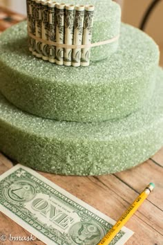 a stack of money sitting on top of a wooden table