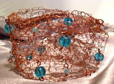 Copper hand-crochet cuff with accents and three hook closures. This copper and blue/turquoise bead cuff is 2X6.5 in. Do not wear with delicate long sleeve sweaters/shirts. The metal may snag the fabric. Copper And Blue, Mermaid Bracelet, Copper Cuff, Beaded Cuff, Turquoise Beads, Blue Beads, Blue Turquoise, Hand Crochet, Turquoise Blue