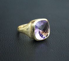 ♦♦ Beautiful handcrafted ring ◘Stone Information: Genuine Amethyst - Color: Purple Cut: Briolette Cushion Size: 15 mm ◘ Metal: 925 Sterling Silver ◘ Band: 4.5 mm textured ◘ Setting: Open back bezel setting ◘ Finish: High polish (shiny) ◘ Nickel free ◘ Anti tarnish ◘ Vermeil Gold ◘ Handmade band: 14 gauge solid sterling wire This ring is adorably rustic, easy to wear, & stackable! ◘Please Note - The Ring in the Picture can be available or Sold out. Every Ring is Made of a Unique Gemstone. The Classic Large Stone Amethyst Ring For Formal Events, Classic Formal Amethyst Ring With Large Stone, Timeless Jewelry Ring With Large Stone, Timeless Jewelry With Large Stone, Timeless Large Stone Ring Jewelry, Timeless Amethyst Gemstone Rings, Timeless Amethyst Ring As A Gift, Elegant Purple Amethyst Signet Ring, Elegant Amethyst Signet Ring Hallmarked