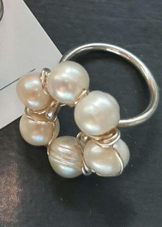 This is a delicate simple design ring, fresh and romantic, perfect for wedding, bridesmaid or just a perfect gift for someone special.  This Lovely ring is handmade with 925 sterling silver and fresh water pearls. Size: select size options All my Jewelry are design and handcrafted  in my home studio, I love to create different and unique designs with  quality material to bring a piece of jewelry that last for years. I invite you to visit my store for more of my designs. https://www.etsy.com/shop/AlbartStudio I'll be glad to answer all of your questions. SHIPPING AND PROCESSING * All my Jewelry comes in a gift presentation for you or for someone you love. * Processing time 1-3 business days. * Shipping by USPS first class mail. * All Item will be insured * I do accept returns withing 5 days Adjustable Round Flower Ring For Wedding, Minimalist Handmade Pearl Ring For Anniversary, Stackable Flower Open Ring For Weddings, Unique Adjustable Flower Ring For Wedding, Minimalist Pearl Ring For Wedding, Unique Sterling Silver Crystal Ring For Wedding, Wire Wrapped Round Wedding Jewelry, Unique Open Stackable Wedding Rings, Elegant Hand Wrapped Jewelry For Anniversary