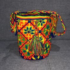 Authentic Colombian Wayuu Bags Each Is One Of A Kind Hand Made By The Tribe In La Guajira Woven Travel Pouch Bag, Woven Pouch Bag For Travel, Multicolor Bucket Shoulder Bag With Adjustable Strap, Multicolor Bucket Shoulder Bag For Festival, Orange Bucket Bag With Adjustable Strap, Bohemian Orange Bag For Shopping, Casual Woven Festival Bag, Casual Woven Bags For Festival, Bohemian Orange Shopping Bag