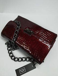 An elegant classic style bag with a strong scent of the legendary original designs that marked deeply the modern fashion, made of high quality genuine greek calf leather, processed properly in order to resemble croc leather. The bag's inner space is seperated in three (3) divisions, as also a zipped pocket is included. The chain is made of black nickel and it's proper for the use of the bag as a Shoulder Bag. The bag includes a safety lock, which can be opened simply via sliding the small round Elegant Textured Leather Rectangular Bags, Elegant Rectangular Faux Leather Bag, Elegant Rectangular Textured Leather Bags, Elegant Textured Leather Baguette Bag, Elegant Faux Leather Clutch Shoulder Bag, Elegant Red Faux Leather Shoulder Bag, Elegant Textured Faux Leather Bag, Leather Baguette Evening Bag With Phone Pocket, Evening Rectangular Bag In Faux Leather