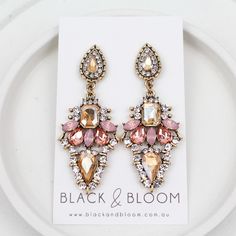 Please note our Sophia Earrings have a vintage gold look and may vary in metal colour, not all pairs are the same and this is why we love them so much! Metal: Zinc Alloy Gold detailing Orange & Pink crystal rhinestones Measurements: Length: 6cm Width: 2.5cm Weight: 16g Gold Crystal Earrings With Jewels, Gold Metal Chandelier Earrings With Rhinestones, Gold Jeweled Drop Earrings, Gold Jeweled Dangle Earrings, Vintage Rose Gold Earrings For Party, Pink Crystal, Gold Details, Orange Pink, Accessories Earrings