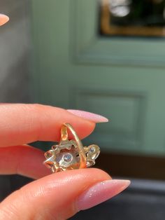 Playful yet elegant, this vintage Retro “Plume” Cluster Ring is a remarkable statement piece. Crafted circa 1940’s, this ring is a glimmering example of the ways 1940’s jewelry continued some of the Belle Epoque design traditions. Note the striking 14 carat yellow gold body of the ring, which juxtaposes beautifully against the 14 carat white gold top. Also beautiful are the cluster of vivid white miniature diamonds, which are arranged in a labyrinthine halo around the pièce de resistance – a gor Vintage Cluster Rings Hallmarked, Vintage White Gold Cluster Ring, Vintage Rose Cut Diamond Cluster Ring, Vintage Cluster Ring With Rose Cut Diamonds, Vintage Diamond Ring With Rose Cut Diamonds, Heirloom Oval Jewelry With Screw Back, Vintage Style Diamond Cluster Ring With Rose Cut, Vintage Yellow Gold Marquise Jewelry, Vintage Yellow Gold Cluster Jewelry