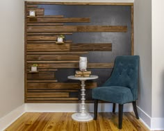 a blue chair sitting next to a white table on top of a hard wood floor