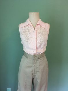 "1940s handmade blouse pink, lightweight cotton sleeveless Mother Of Pearl buttons lace front detail waist darts up front bust darts from side slanted up beautiful long collar pointed down good vintage condition w/wear- patched and mended by me(see last 3 pictures) measures, lying flat, shoulder-13\" chest-17\" waist-14\" hem-18\" length-23\"     We do not offer returns or refunds unless something is grossly misrepresented. Please contact us within 2 business days of receiving to discuss any possible returns for this reason. We do not offer refunds for your shipping fees. Please feel free to contact us with any questions you may have about an item prior to purchase and we will gladly answer them." Fitted Cotton Shirt With Lace Trim, Summer Fitted Shirt With Lace Collar, Fitted Shirt With Lace Collar For Summer, Vintage Lace Collar Button-up Top, Fitted Button-up Blouse With Lace Collar, Feminine Fitted Collared Blouse, Fitted Lace Collar Button-up Blouse, Feminine Fitted Blouse With Collar, Fitted Sleeveless Blouse With Button Closure