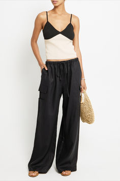 With its oversized, relaxed fit and long loose legs, these pants are a comfortable and cool choice for any occasion. The adjustable drawstring waist and cargo pocket details add both function and fashion to this must-have piece. Relaxed Wide Leg Parachute Pants With Pockets, Chic Straight Cargo Parachute Pants, Chic Cargo Style Straight Parachute Pants, Casual Linen Pants With Multiple Pockets, Wide Leg Cargo Style Parachute Pants For Loungewear, Chic Straight Parachute Pants With Cargo Pockets, Chic High-waisted Parachute Pants With Cargo Pockets, Chic Parachute Pants With Pockets, Chic Cargo Pants With Pockets For Day Out