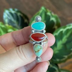 This triple stone ring has lots of fun colors going on with both green and blue turquoise and a deep orange carnelian.  She is a vibrant statement piece with a rustic vibe.  I gave her sterling silver bead accents and a textures sterling split shank band. Measurements:  47mm x 16mm Ring Size:  8.5 Turquoise is known as the master healing stone.  Attributed to the power of connecting mind, body, and soul, it is also a symbol of superior energies and spiritual openness. Known as an artist's stone, the Carnelian crystal is a warm, vibrant stone that boosts confidence and the power of true expression.  This stone empowers your self-confidence in all aspects of your life - from relationships and professional pursuits to personal projects. When you are searching for a stone to help you tap into Bohemian Turquoise Multi-stone Rings, Unique Turquoise Multi-stone Rings, Bohemian Oval Multi-stone Turquoise Ring, Bohemian Oval Multi-stone Rings, Handmade Multicolor Artisan Turquoise Ring, Handmade Artisan Multicolor Turquoise Ring, Green Handmade Turquoise Ring For Spiritual Use, Bohemian Green Chrysoprase Ring, Bohemian Turquoise Gemstone Ring