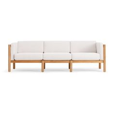 a white couch sitting on top of a wooden frame