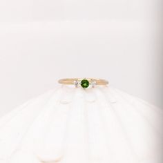 This beautiful ring features a 0.12 carat round Tsavorite gemstone with natural earth mined diamonds set in solid 14k gold. This ring makes a lovely January birthstone gift for your loved ones! This ring is made with solid 14K Gold and natural Earth mined SI / G-H diamonds. If you're interested in purchasing this setting with a different center stone please message us! Tsavorite Fine Jewelry Birthstone Promise Ring, Green Round Cut Birthstone Ring In 14k Gold, Tsavorite Promise Ring For May Birthstone, Green 14k Gold Round Cut Birthstone Ring, Green 14k Gold Birthstone Ring With Round Cut, Tsavorite Birthstone Ring, Green Three Stone Birthstone Ring In 14k Gold, Tsavorite Birthstone Ring For May, Green 14k Gold Promise Birthstone Ring