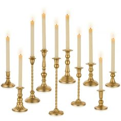 a set of twelve brass candlesticks with lit candles in the middle and on each candle holder