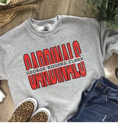 These GRC Cardinal shirts are a perfect addition to your school spirit wear!   ❗️Sizes: Toddler-2T-5T  Youth XS-XL  Adult S-XL  Adult 2X Adult 3X Available in short sleeve, long sleeve and sweatshirts!  Shirts are all unisex sizing! Shirt Color shown in Ash Gray and Sport Gray. Can do on any color, but design colors will not fully show on black or white shirts. This is a vinyl design on the shirt.  If you would like to request a custom order, please send us a message!! Cheer Designs, Cardinals Game, School Spirit Wear, School Store, School Spirit Shirts, Clark County, Spirit Shirts, Ash Gray, Teacher Things