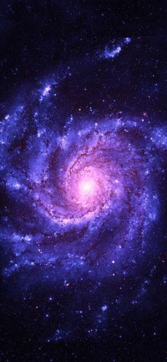 an image of a spiral galaxy in the night sky with blue and purple stars around it