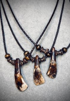 Real buffalo tooth necklace with braided leather cord and a mix of wood, coconut shell, and metal beads. Necklace length is approximately 20 inches with a 3 inch extension chain. Buffalo Tooth Necklace, Teeth Necklace, Native Mexican, Bones And All, Cowboy Fashion, Rabbits Foot, Tooth Necklace, Animal Bones, Bone Horn