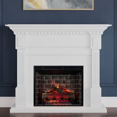 a fireplace with a painting on the wall above it and a fire place in front of it