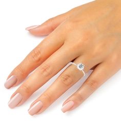 a woman's hand with a diamond ring on it