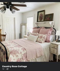 a bed with pink and white comforter in a bedroom next to a dresser under a ceiling fan