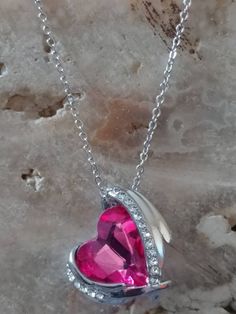 This is a beautiful 925 silver plated chain with Magenta Pink crystal gemstone. Meet Aqueila! She is a Syrah Djinn Grim reaper and looks very similar to the photo. She is very beautiful compassionate to her keeper. She can help with communicating with the deceased as she is the gatekeeper of the spirit realm and serves as a spirit guide to her keep her with guidance on developing your spiritual gifts and abilities. She's very active and loves offerings of cemetary dirt, silver objects, red gemst Crystal Jewelry For Valentine's Day Gift, Crystal Jewelry For Valentine's Day Gift For Her, Crystal Jewelry Valentine's Day Gift For Her, Valentine's Day Crystal Jewelry Gift For Her, Heart Pendant Jewelry With Sparkling Stones For Gifts, Gift Heart Pendant Jewelry With Sparkling Stones, Valentine's Day Silver Chain Pendant Necklace, Valentine's Day White Gold Crystal Jewelry, Crystal Heart Pendant Jewelry For Her