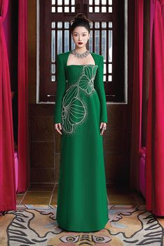 Elevate your style with the luxurious dress. The elegant A-line silhouette and regal Queen Anne neckline exude sophistication, while the soft velvet and smooth satin fabric add a touch of opulence. Make a statement and feel like royalty in this exclusive piece. * Note: The photo of the dress product is sketched based on the ao dai product and is for reference only. Dress products will not have slits on either side. Luxury A-line Evening Dress For Gala, Elegant Green A-line Gown, Luxury A-line Gown With Fitted Bodice, Elegant Green A-line Evening Dress, Luxury A-line Cocktail Gown, Luxury Silk A-line Evening Dress, Luxury A-line Dress For Banquet, Elegant A-line Gala Gown, Luxury Green Gown For Banquet