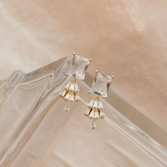 Add a touch of luxury to any look with these exquisite Dainty Gold Earrings. Crafted from yellow gold, these statement earrings feature an Art Deco design with a rectangular cubic zirconia post. These dainty earrings will elevate any ensemble and are sure to become your go-to jewelry staple. #daintygoldearrings #artdecojewelry #bridalearrings #wanderandlustjewelry Art Deco Wedding Jewelry, Art Deco Bride, Wedding Jewelry Sets Bridal Jewellery, Dainty Gold Earrings, Classic Bride, Earrings Art Deco, Jewelry Staples, Deco Earrings, Earrings Art