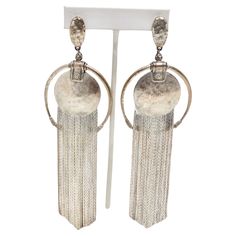 Get your hands on the Jean Paul Gaultier 1990s Silver Fringe Hoop Dangle Earrings, a stunning pair of statement earrings that reflect the artistry and iconic design of this renowned fashion designer. These earrings are the work of Jean Paul Gaultier, a legendary designer known for his innovative and daring fashion creations. Owning a piece from such a prestigious designer is a testament to your fashion-forward style. The bold design of these earrings, featuring silver O rings and circle charms w Hoop Dangle Earrings, Iconic Design, Paul Gaultier, Bold Design, Jean Paul Gaultier, Jean Paul, O Ring, Hands On, Statement Earrings