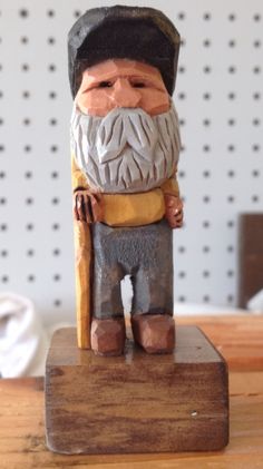 a wooden statue of a man with a long beard