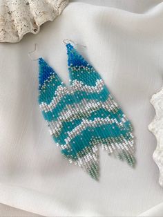 Thoughts about the ocean don't leave me, so I decided to create a piece of the waves for you. These exclusive ocean wave bead earrings are really good at vacation! Long blue and turquoise beaded earrings with sparkling beads remind you of the ocean breeze. It can be a cute gift for your loved ones. Also, you can complement your holiday look with these fringe earrings. ♡ Bead Length - 4.7'' (12 Centimeters) ♡ Total Length - 5.1'' (13 Centimeters) ♡ Width - M-size - 1.2'' (3 Centimeters) L-size - Ocean Beaded Earrings, Blue Round Beads With Beaded Fringe, Bohemian Blue Beaded Earrings With Tiny Beads, Blue Beaded Earrings For The Beach, Turquoise Earrings With Beaded Fringe For Beach, Blue Beaded Fringe Earrings For Beach, Blue Beaded Fringe Earrings For Jewelry Making, Colorful Blue Beaded Earrings For Beach, Handmade Blue Beaded Earrings For Beach