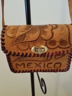 a brown leather purse hanging from a hook