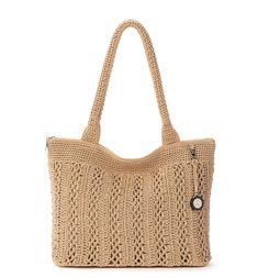 a crocheted straw bag with a button on the front and side closures