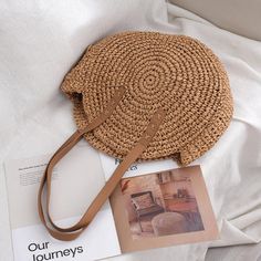 Unleash Vintage Vibes with Our Handcrafted Round Straw Beach Bag Step into the allure of bohemian elegance with our exquisite Round Straw Beach Bag. Handwoven to perfection, this timeless piece by Yogodlns encapsulates the essence of vintage charm and artisan craftsmanship. Unique Features Handcrafted from premium quality straw for durability and eco-friendliness Soft polyester lining ensures the safety of your essentials Spacious interior with a cell phone pocket for easy organization Zipper cl Bohemian Beige Beach Bag With Large Capacity, Cream Bohemian Shoulder Bag For Beach Season, Bohemian Cream Shoulder Bag For Beach Season, Bohemian Large Capacity Shoulder Bag For Beach Season, Bohemian Bucket Bag With Large Capacity For Vacation, Brown Bohemian Bucket Bag For Beach Season, Bohemian Brown Bucket Bag For Beach Season, Bohemian Beige Bucket Bag For Vacation, Bohemian Cream Straw Shoulder Bag