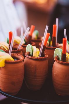 small cups filled with different types of food on top of a table next to each other