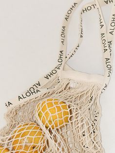 Sport an effortlessly chic look with our Cotton Net Bag. Its lightweight nature and trendy look makes it the perfect accessory to bring to a casual trip to the beach, the market, or to a party! Made with 100% cotton and lined with ALOHA on its straps. Available in 14 different colors! Length: 25.5 in Width: 14 in Beige Cotton Canvas Bag For Vacation, Vacation Cotton Shoulder Bag With Adjustable Strap, Summer Beige Cotton Canvas Bag, Summer Cotton Canvas Bag For Vacation, Summer Cotton Shoulder Bag With Adjustable Strap, Summer Cotton Bag With Adjustable Strap, Summer Cotton Canvas Bag, Cotton Shoulder Bag For Beach Vacation, Summer Canvas Bag With Adjustable Strap