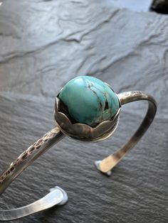 Turquoise and sterling cuff bangle bracelet, bezel set charm silver stacking bracelet, gift for her Featuring a bezel set vintage Tyrone turquoise charm set in sterling silver. The stone sits atop a sterling silver bangle which has been hammered, oxidised and polished. The bracelet is a small 6 - 6.5" wrist.  **Please note this type of bangle fits sideways on to the wrist** You can gently widen the cuff if need be. Wear alone or stacked with other jewellery. **Please note this type of bangle fit Unique Stackable Turquoise Jewelry, Unique Turquoise Stackable Jewelry, Handmade Round Turquoise Bracelets, Stackable Turquoise Round Jewelry, Turquoise Stackable Bangle Jewelry, Stackable Turquoise Bangle Jewelry, Bohemian Bangle Jewelry For Anniversary, Artisan Turquoise Cuff Bracelet In Sterling Silver, Unique Turquoise Sterling Silver Bracelets