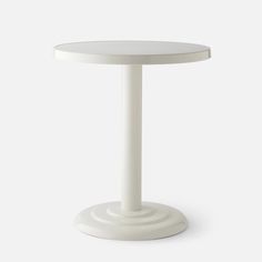 a white table with a round top and base on a white background, there is no image here to provide a caption for