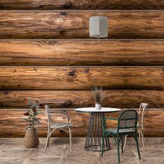 two chairs and a table in front of a log wall