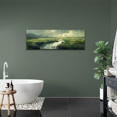 a bath room with a tub and a painting on the wall