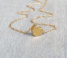 The most dainty gold necklace, such a cute tiny 14K gold-filled heart necklace. Little goldfilled heart on a dainty 14k goldfilled chain. Perfect with layering with other necklaces in my shop! The necklace on the model measures 16 inches. 14k goldfilled little heart pendant measures 6 mm, so simple and sweet! You can wet the necklace and it will not tarnish - Acts like real gold Photo #5 - Sterling Silver necklace (choose your choice from the drop-down menu) ♥ It comes in a beautiful package rea Delicate Gold Heart Charm Necklace, Dainty 14k Gold-filled Yellow Gold Heart Necklace, Dainty 14k Gold Filled Heart Necklace, Dainty 14k Gold-filled Heart Necklace In Yellow Gold, Dainty Tiny Gold Heart Necklace, Minimalist Gold Heart Pendant Charm Necklace, Gold Minimalist Open Heart Charm Necklace, Minimalist Gold Open Heart Charm Necklace, Delicate Gold Open Heart Charm Necklace