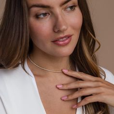 Give the gift of sparkle this holiday season with our Diamond Tennis Choker Necklace. Featuring dazzling diamond gemstones on a delicate chain, this versatile piece adds elegance to any look—from casual outings to glamorous date nights. A perfect Christmas gift to make someone shine. SKU: RR-NR152 Product Details Finish/Material: 18K Gold Over Brass ∙ Rhodium Over Brass, CZ Diamond Gemstones Featuring a Dainty ~2mm CZ Diamond Tennis Choker Necklace, available in 2 lengths: 14 Inches + 2 Inch Ext Rose Gold Diamond Cut Tennis Necklace, Crystal Pearl Necklace With Clavicle Chain, Classic Diamond White Jewelry With Adjustable Chain, White Gold Diamond Accent Choker Necklace, White Gold Diamond Accented Choker Necklace, Adjustable Solitaire Necklace, Round Cut, White Gold Diamond Accents Choker Necklace, Elegant Rose Gold Tennis Necklace For Gifts, Elegant Rose Gold Tennis Necklace Gift