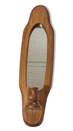 a wooden mirror mounted to the side of a wall