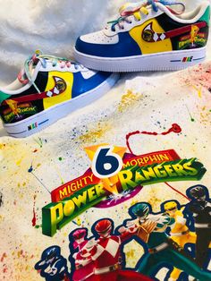 two shoes with the number six painted on them are next to some paint splatters