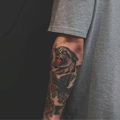 a man with a bird tattoo on his arm