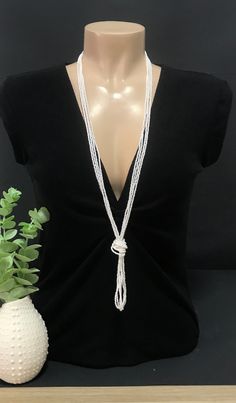 "This is a pearl beaded long necklace that measures about 44 inches long in total . The knot is adjustable, simple to undo and redo at the height you would like! Or you can wear the necklace double up without any knot! It is a very versatile necklace that can be adapted to your taste.   ❤ PROCESSING AND SHIPPING Most orders are made and shipped out in one business day. Please check delivery timeframes for your location on the description below.  ❤ CUSTOM ORDERS If you like this item in a different color, send me a message indicating: color, size and quantity needed. I will send you a link for a \"custom order\" and you'll be able to place the order there.  If you like this item with some variations such as thickness or style, please also send me a message and I will work with you! Go back Elegant Multi-strand Beaded Chain, Multi-strand Beaded Necklaces With Pearl Drop For Weddings, Multi-strand Beaded Necklace With Pearl Drop For Wedding, Multi-strand Pearl Drop Beaded Necklaces For Weddings, Elegant Beaded Multi-strand Bridal Necklace, Wedding Multi-strand Beaded Necklaces With Pearl Drop, Wedding Multi-strand Beaded Necklace With Pearl Drop, White Beaded Chain Lariat Necklace, White Lariat Necklace With Beaded Chain