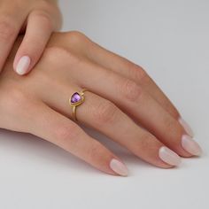 This gorgeous ring features a lavender-pink, rose cut sapphire wrapped in warm 22k gold, and accented with a single sparkling diamond. This ring is lovely on its own, and stacks beautifully with others in the collection. The setting measures approximately 6.5mm x 7.5mm. 18k gold 1.5mm, hammered band. Matte finish. Purple Diamond Ring With Rose Cut For Gift, Purple 14k Gold Ring With Rose Cut Diamonds, Gold Pink Sapphire Diamond Wedding Ring, Gift Purple Pink Sapphire Ring, Anniversary Pink Sapphire Ring With Rose Cut Diamonds, Purple Rose Cut Diamond Rings In 14k Gold, Purple 14k Gold Rings With Rose Cut Diamonds, Gold Diamond Ring With Pink Sapphire For Wedding, Gift Pink Sapphire Ring With Rose Cut Diamonds