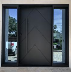 the front door is black and has an arrow design on it