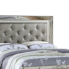 a bed with a silver headboard and foot board on it's side, in front of a white background