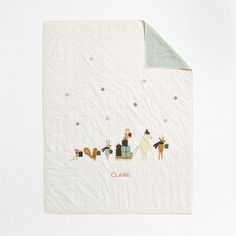 a white blanket with animals and snowflakes on it