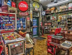 a room filled with lots of old fashioned machines and tables covered in coca cola memorabilia