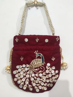 This beautiful Potli or batawa bag are eye catchy and made of premium material. Key Features: Potli Bag Dimension --- 10*8 Inches Embroidery art work This potli is good match with both Indian and western outfits and are superb for wedding and festive parties This would be best complement to your designer saree, lenhga or any other kind of dress This is the combination of traditional and modern embroidery work This is enough to keep your accessories and all needed essentials and it can be a best Bollywood Style Rectangular Potli Bag With Dori Work, Red Shoulder Bag For Festive Gift, Festive Red Shoulder Bag As Gift, Festive Red Shoulder Bag For Gifts, Red Embroidered Potli Bag For Party, Handwork Rectangular Potli Bag For Diwali, Festive Multicolor Potli Bag With Latkans, Traditional Handmade Shoulder Bag For Party, Traditional Gold Shoulder Bag For Festivals