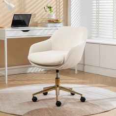 an office chair sitting on top of a rug in front of a desk with a laptop